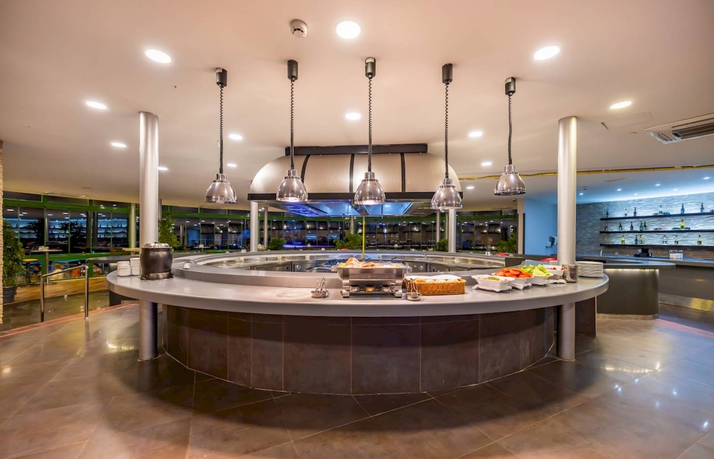 Innenbereich des Restaurants im VONRESORT Golden Coast mit einer Rundtheke und mehreren Lampen.