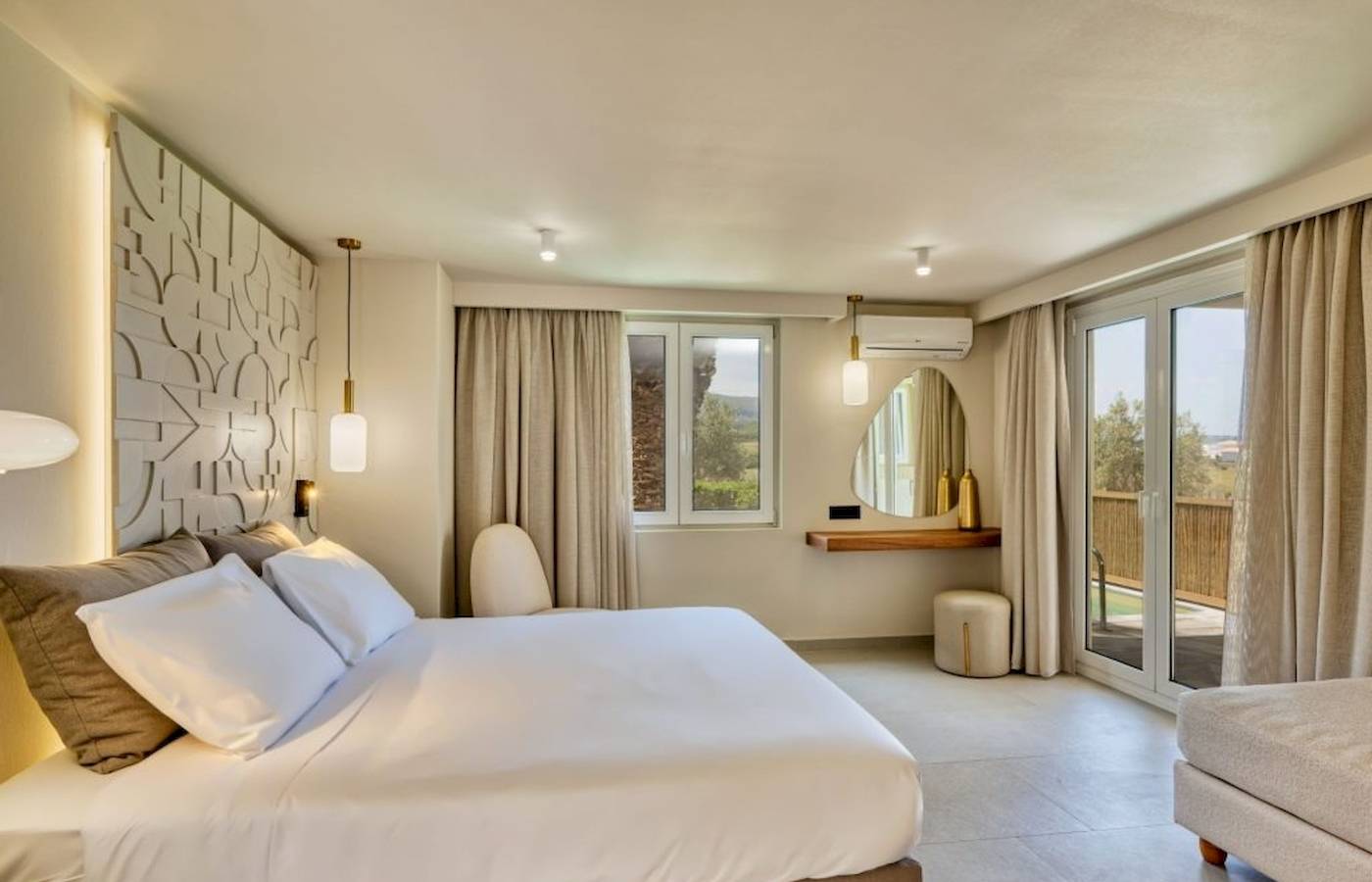 Schlafzimmer im Georgioupolis Resort Aquapark & SPA mit einem großen Bett, weißen Laken, Kissen, und offenem Fenster.