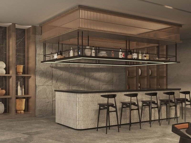 Innenansicht der Bar im Jaz Elite Amara Hotel mit einer Theke und Stühlen.