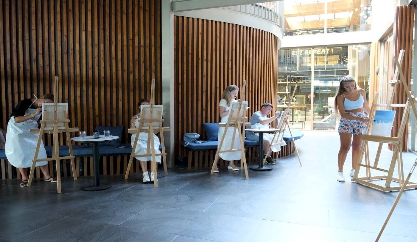 Gäste im Nirvana Cosmopolitan Hotel malen an Staffeleien