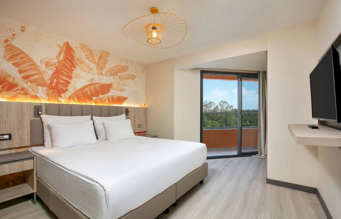 Megasaray Resort Side Hotelzimmer mit Terrasse und Ausblick auf Bäume.