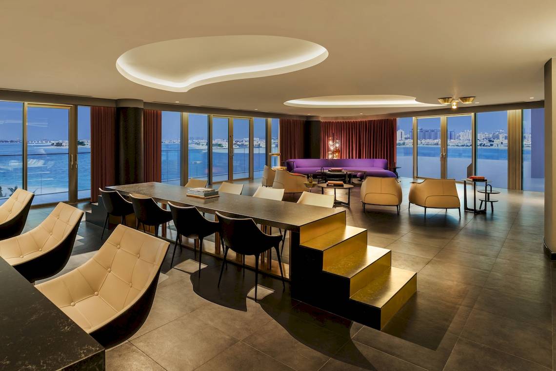 Innenraumansicht des W Dubai - The Palm mit modernem Möbeldesign und Ausblick auf das Meer.