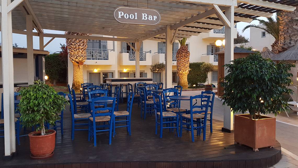 Außenbereich des Pool-Bars des Europa Beach Hotel & Spa mit blauen Stühlen und Tischen.