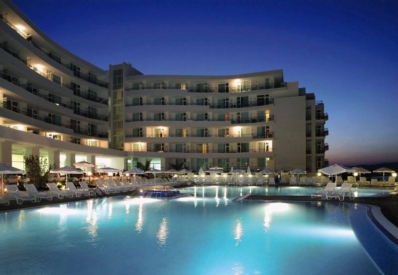 Festa Panorama Hotel Pool bei Nacht mit leuchtenden Fenstern und Sonnenliegen
