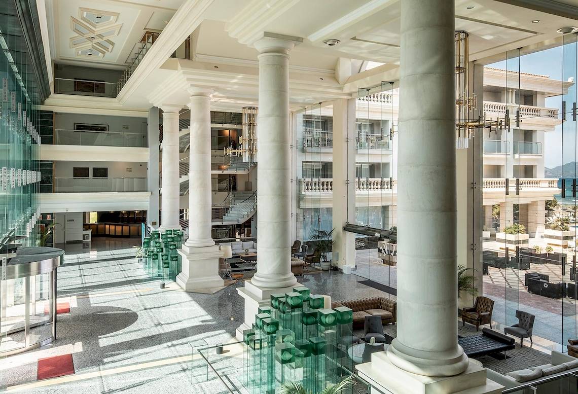 Sarena de Muro Resort Mallorca Hotellobby mit hohen Säulen und modernen Möbeln.