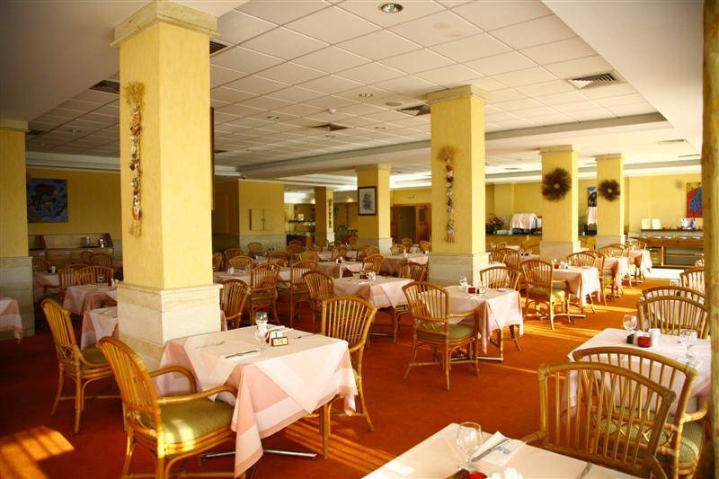 Innenansicht des Restaurants im Bella Napa Bay Hotel mit vielen gedeckten Tischen und Stühlen.
