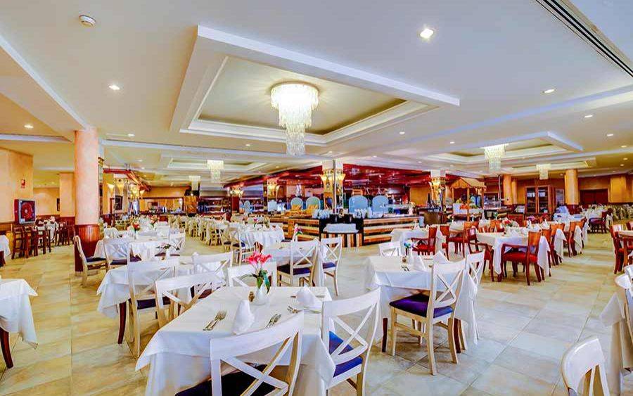 Innenansicht des Restaurants im SBH Costa Calma Beach Resort mit gedeckten Tischen und Stühlen.