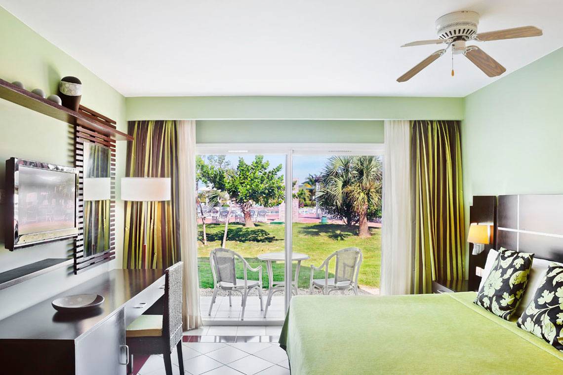 Zimmer im Valentin Varadero El Patriarca Hotel mit Blick auf Terrasse und Garten.