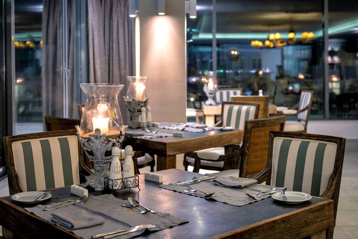 Gedeckter Tisch im Diamond Deluxe Hotel Restaurant mit Kerzen und Speisekarten.