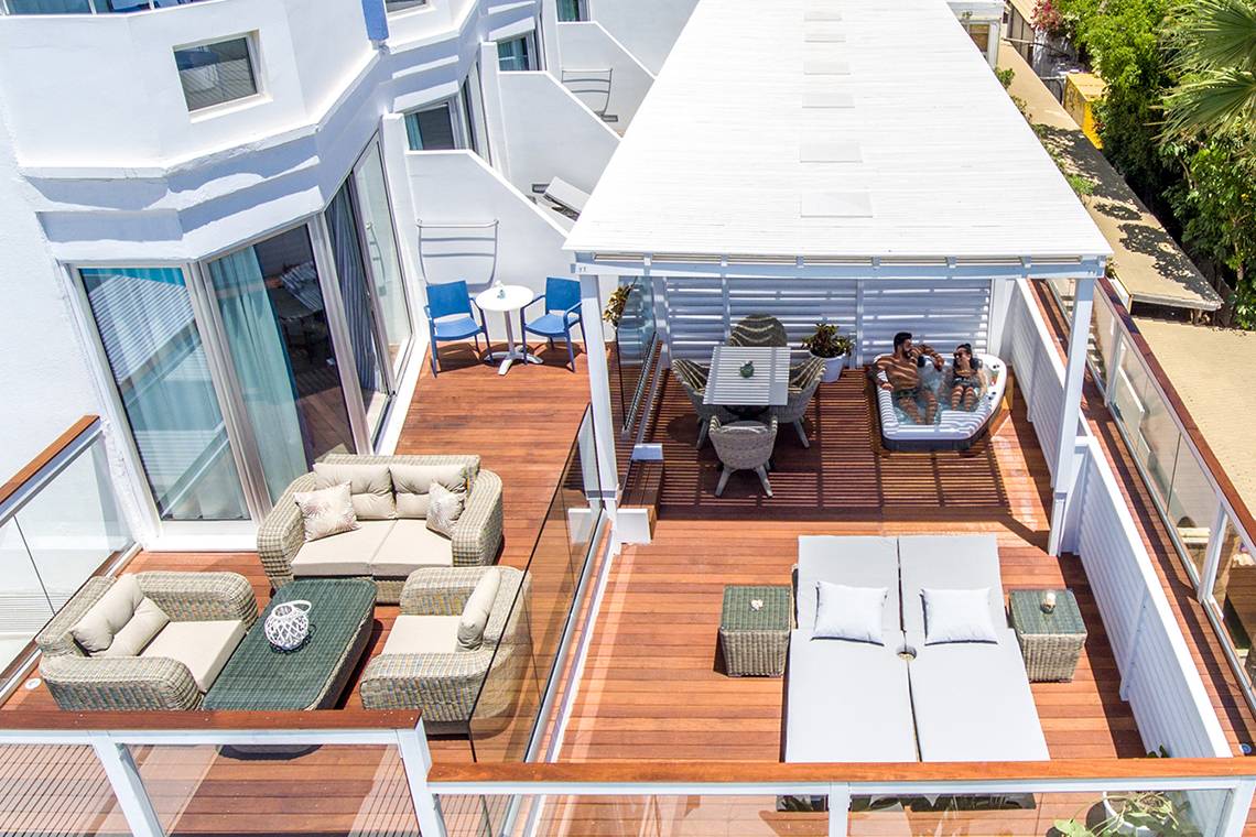 Aussenbereich der Dachterrasse im Lordos Beach Hotel mit Loungebereich und Sonnenliegen.