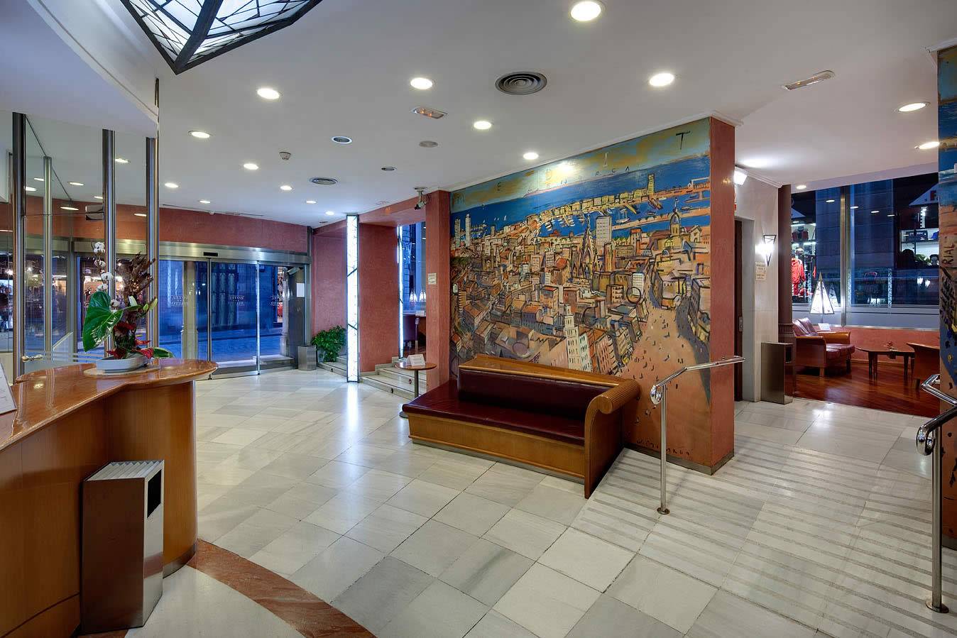 Eingangsbereich des Gargallo Rialto Hotels mit einer großen Wandmalerei und einer Empfangstheke.