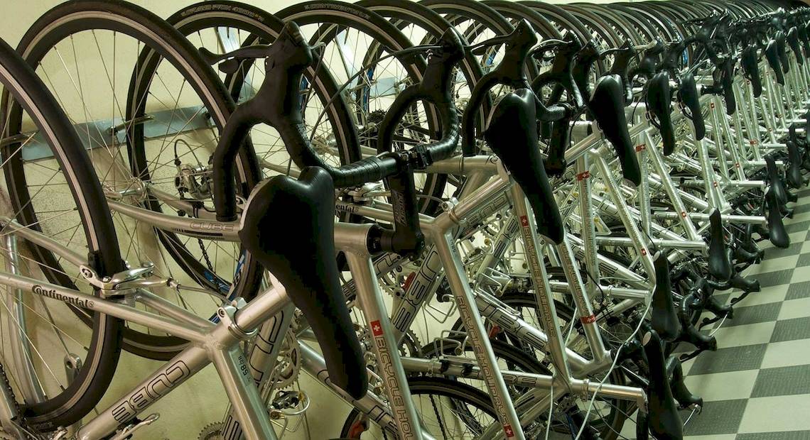 Eine Reihe von Fahrrädern, die nebeneinander in einer Reihe geparkt sind.