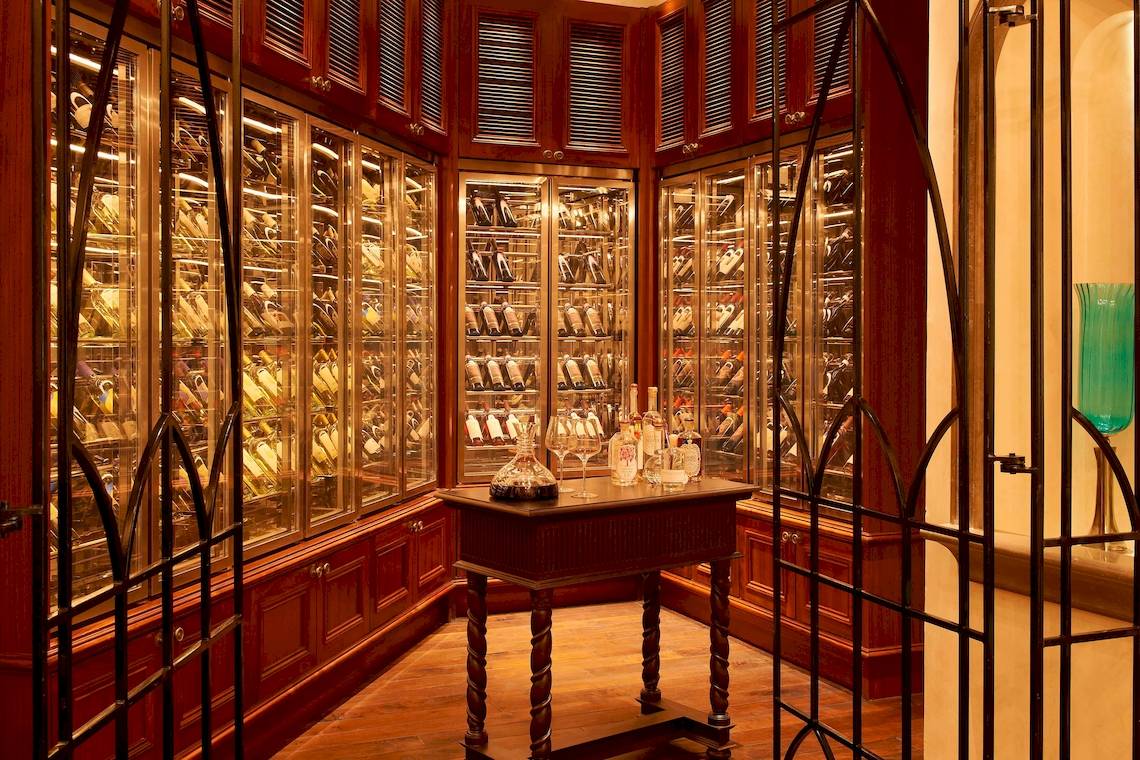 Weinkeller im St. Regis Abu Dhabi mit klimatisierten Weinschränken und Flaschen.