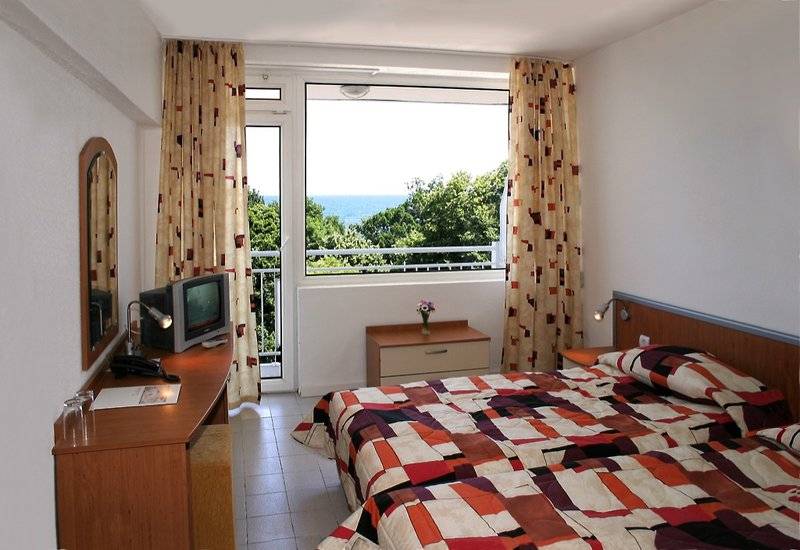 Schlafzimmer mit Meerblick im Gladiola Star Hotel, mit zwei Betten, Fernseher und Balkon.