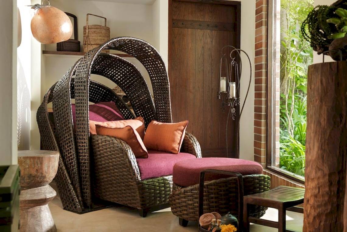Lounge Stuhl mit Kissen im Rayavadee Hotel, umgeben von dekorativen Elementen.
