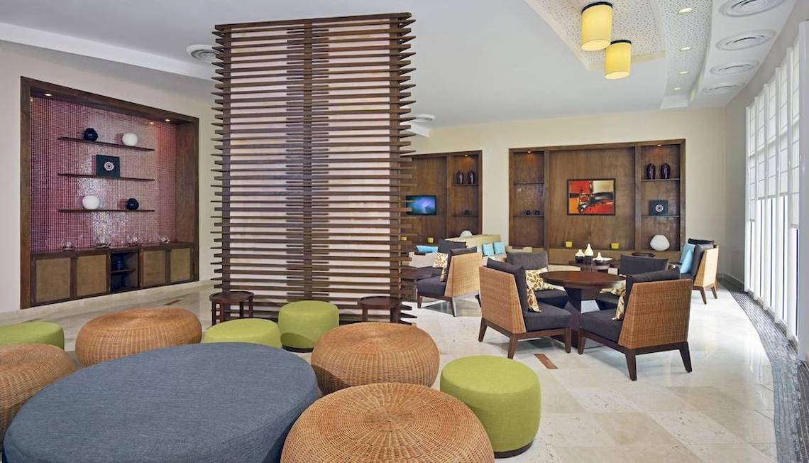 Lounge-Bereich im Paradisus Princesa del Mar Resort & Spa mit Möbeln und Dekoration.