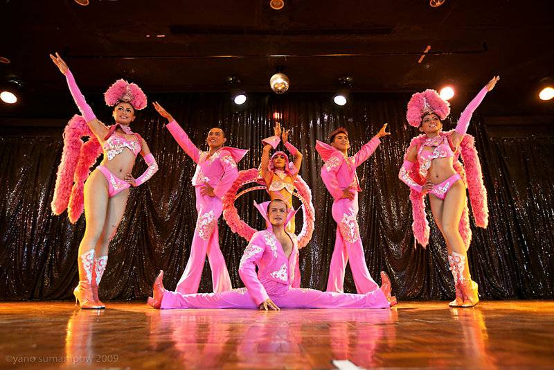 Eine Gruppe Tänzer in pinken Kostümen auf der Bühne einer Show.