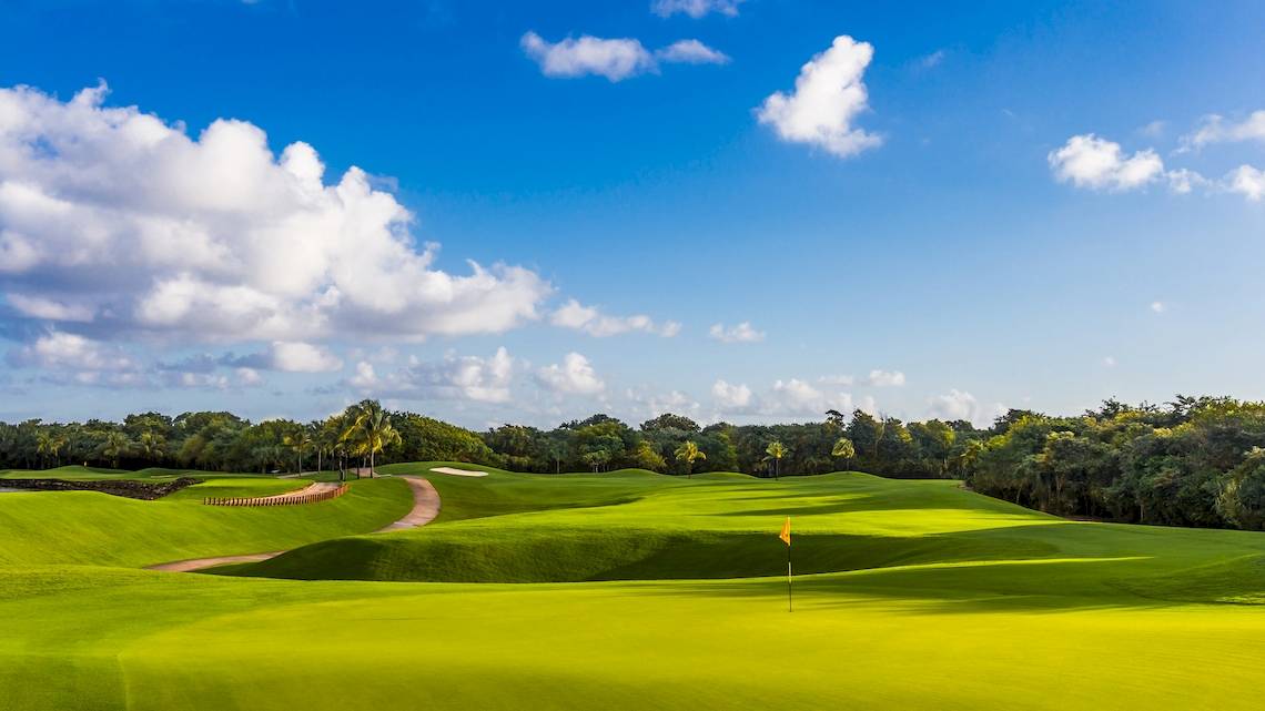 Golfplatz im Iberostar Paraiso del Mar Hotel mit blauem Himmel und Wolken.