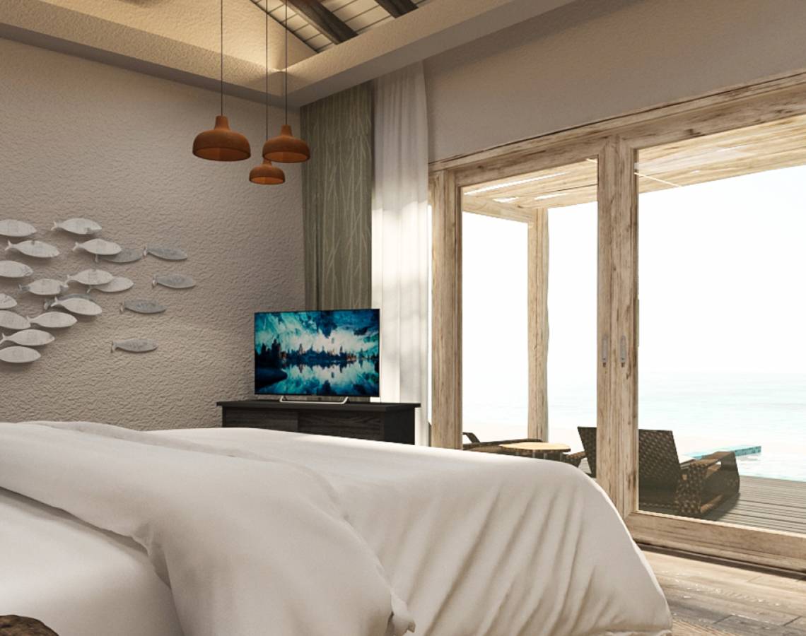 Schlafzimmer mit Bett, Fernseher und Meerblick im You & Me Maldives