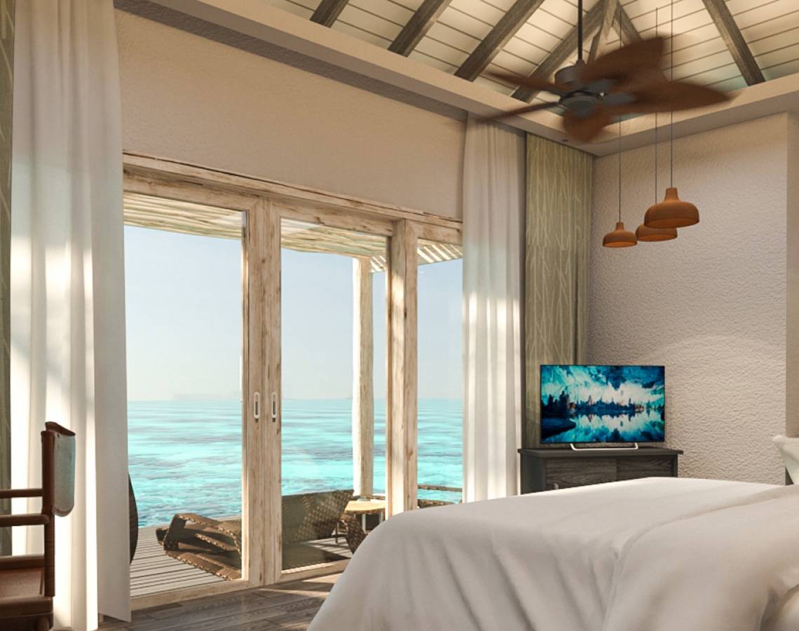 Schlafzimmer mit Meerblick im You & Me Maldives Hotel mit offenem Balkon und Fernseher.