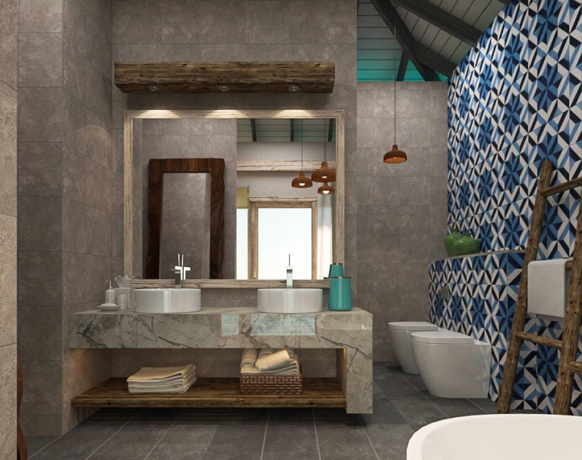 Modernes Badezimmer mit grauen Fliesen und blauen Mustern, zwei Waschbecken und Toiletten