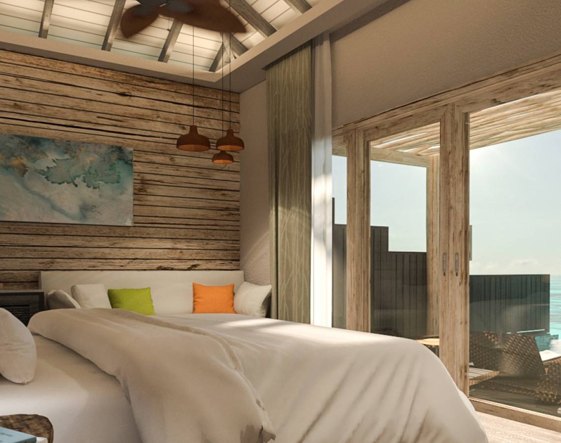 Schlafzimmer mit Meerblick im You & Me Maldives Hotel mit Holzwänden, Bett und Fenstern.