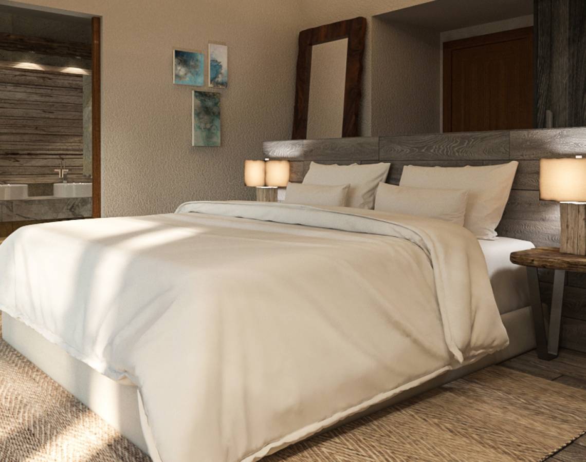 Schlafzimmer im You & Me Maldives Hotel mit weißem Bett und Nachttischen.