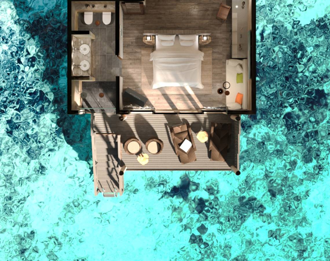 Luftaufnahme der You & Me Maldives Suite mit einem Doppelbett und Badezimmer.