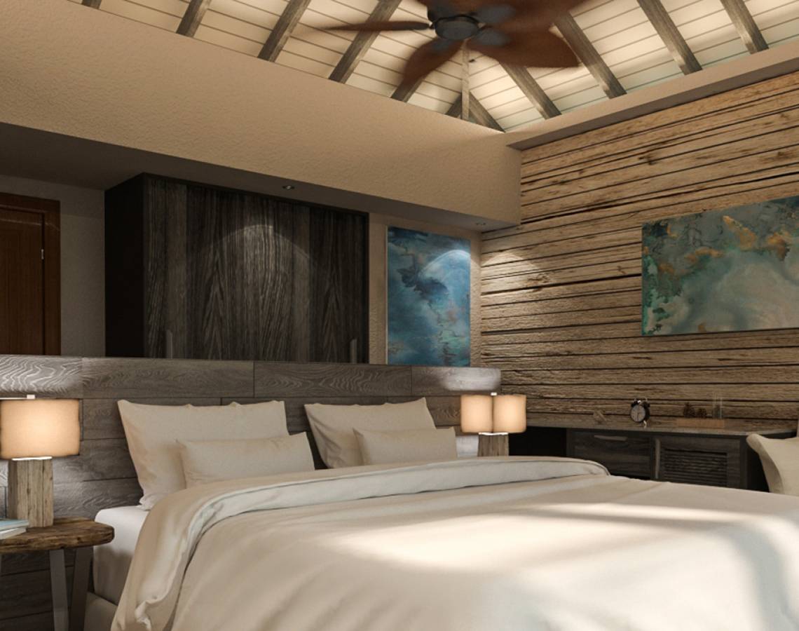 Innenansicht eines Schlafzimmers im You & Me Maldives Hotel mit Holzwänden und einer großen Bett.