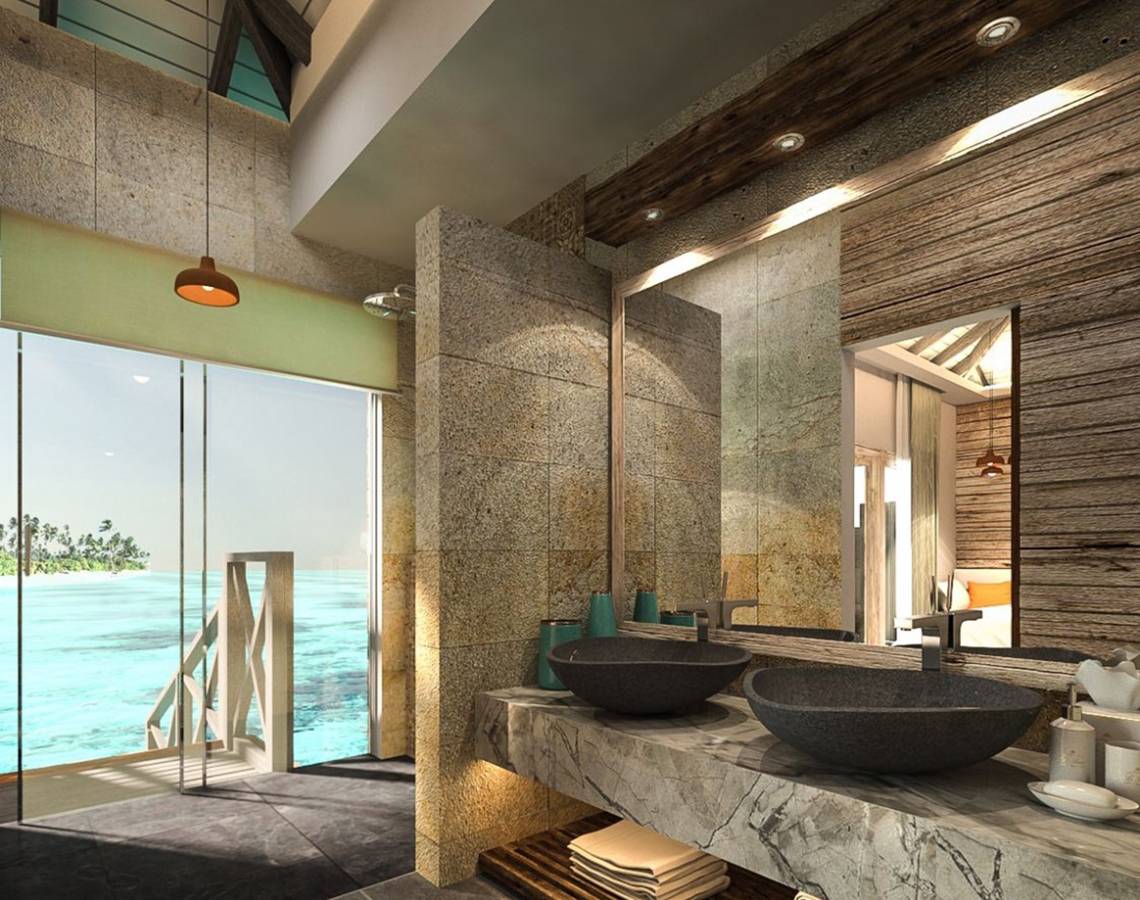 Badezimmer mit Meerblick im You & Me Maldives Hotel, mit zwei Waschbecken und einer großen Glastür.
