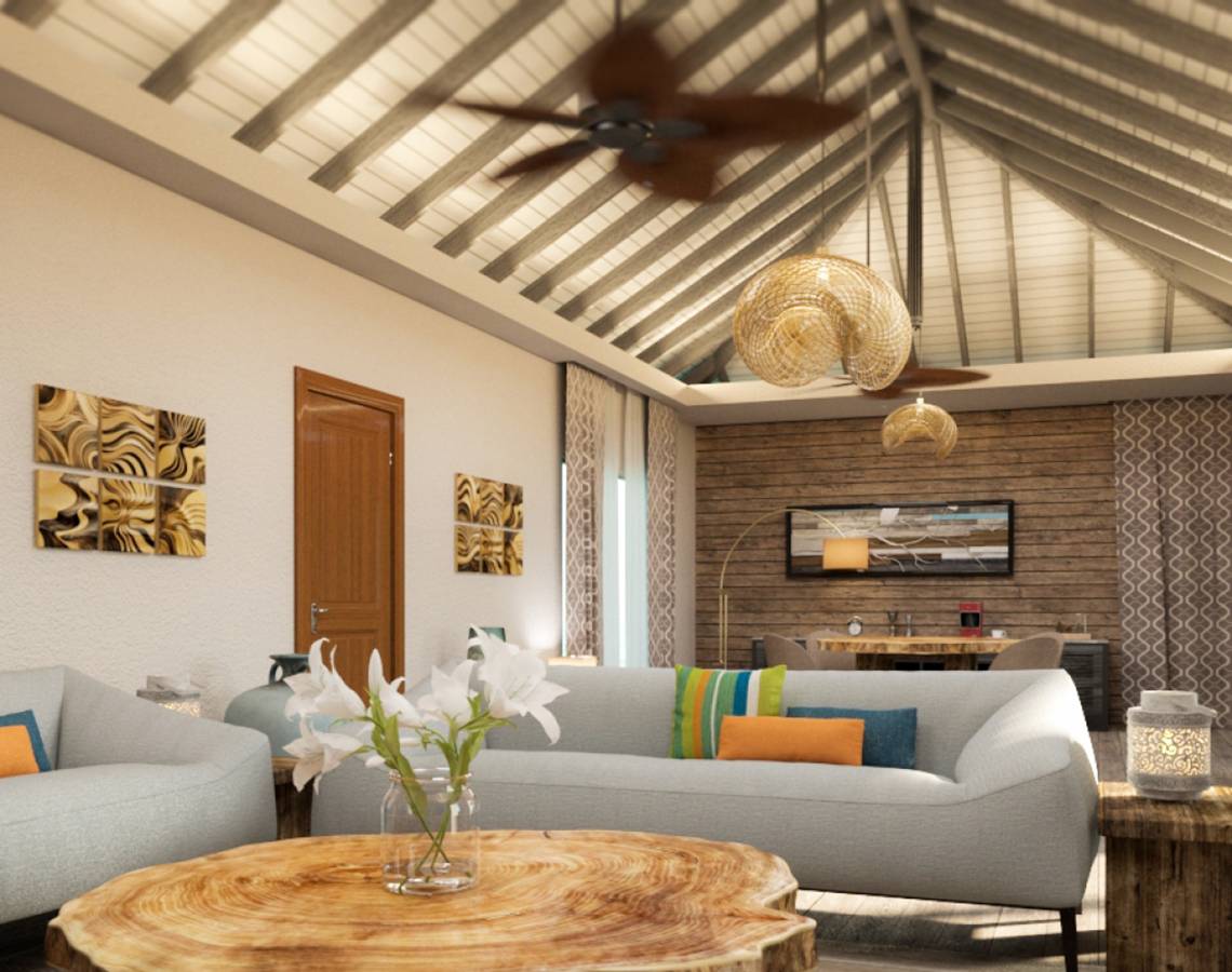 Wohnzimmer von You & Me Maldives mit Couch, Tisch und Dekoration.