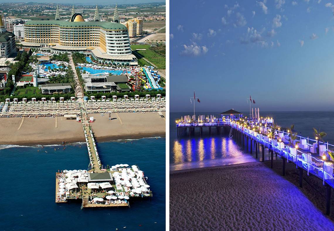 Luftaufnahme des Delphin Imperial Hotels mit Strand und Pier bei Sonnenuntergang