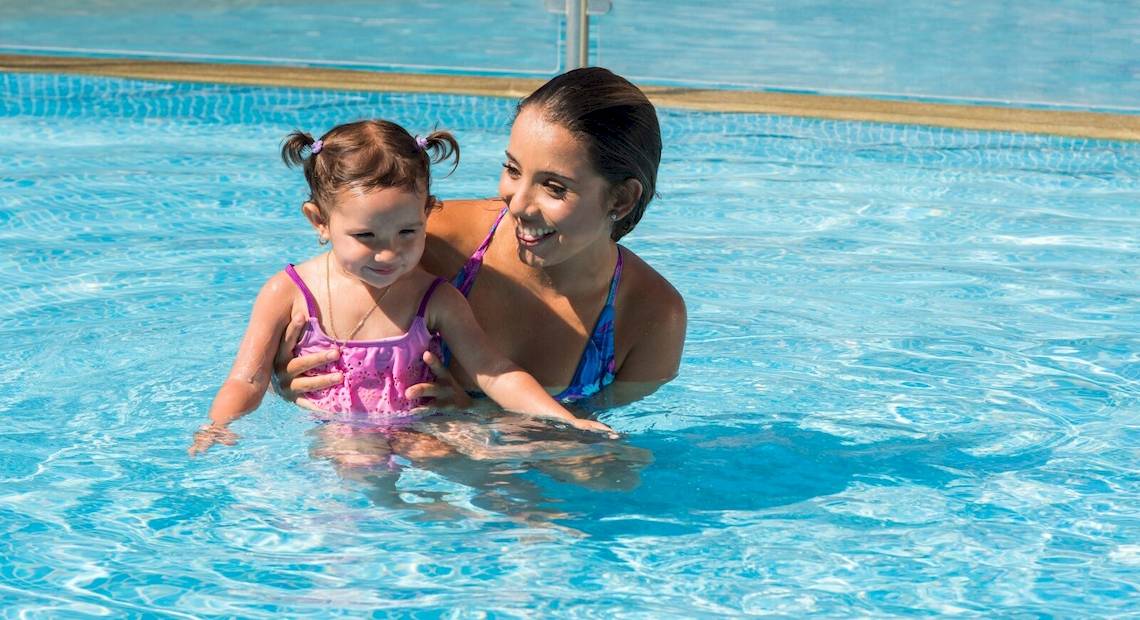 Mutter und Tochter schwimmen im Pool des Occidental Tamarindo