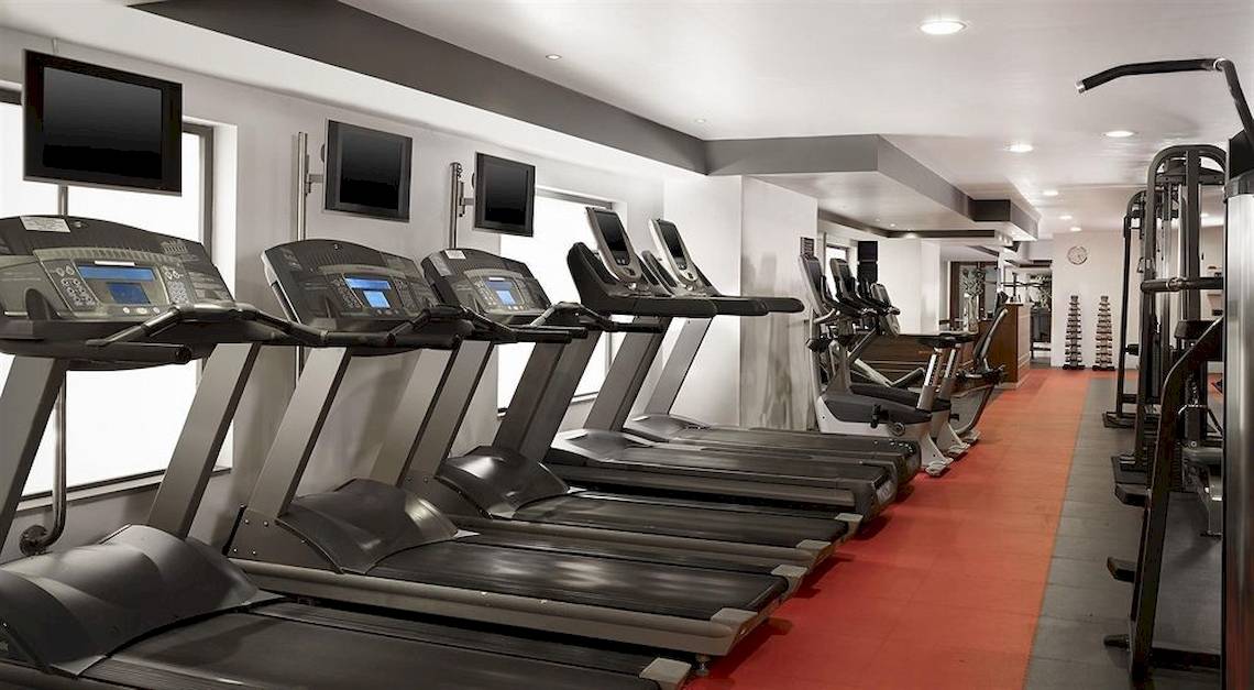Fitnessstudio im Malta Marriott Hotel & Spa mit mehreren schwarzen Laufbändern und anderen Trainingsgeräten.