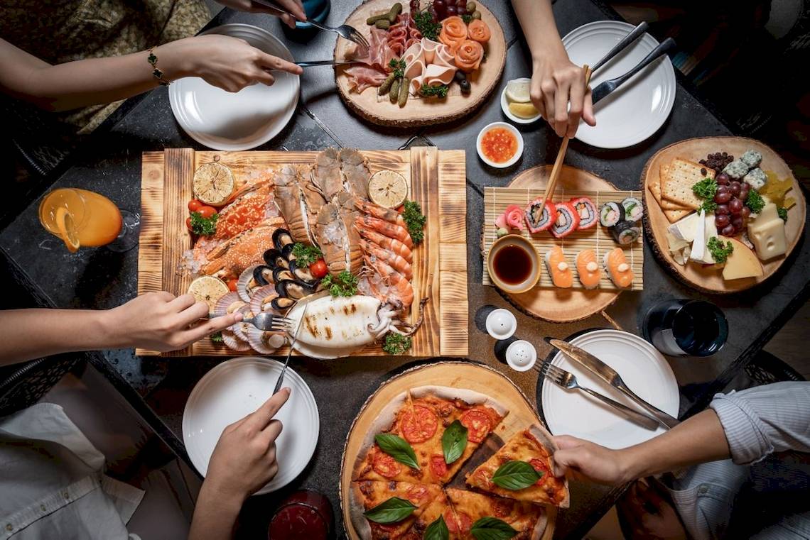 Fünf Personen essen ein Buffet im Four Points by Sheraton Phuket Patong Beach Resort.