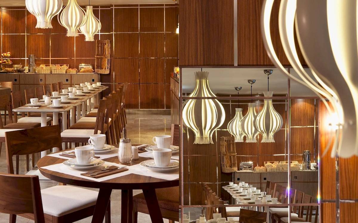 Innenbereich des Les Jardins d'Eiffel Restaurants mit gepflegten Tischen und Holzwänden.