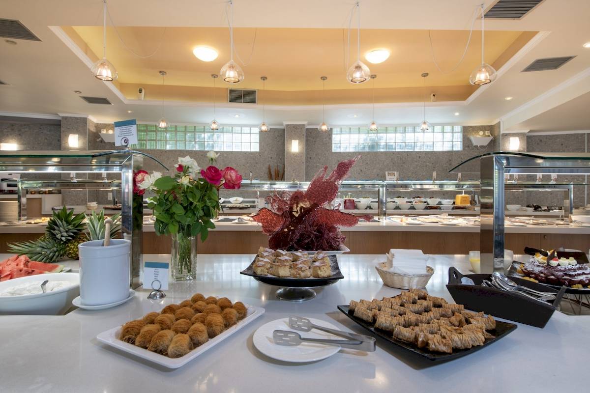 Buffet-Tisch im Hotel Hydramis Palace Beach Resort mit verschiedenen Desserts und Früchten.