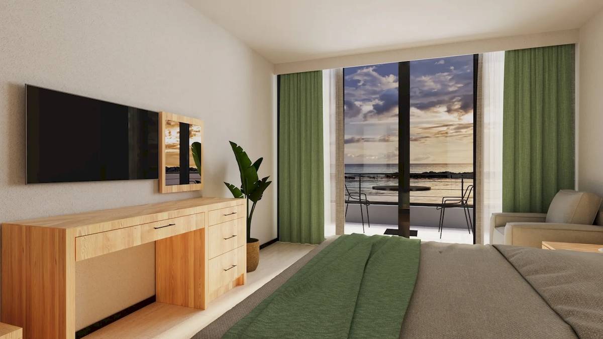 Suite-Zimmer im Sunrise Queen Luxury Hotel mit Blick auf das Meer und einem Balkon.