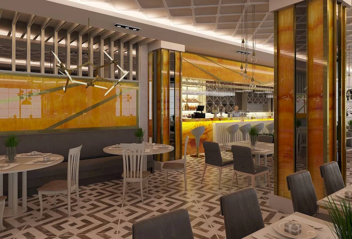 Innenansicht des Restaurants des Sunrise Queen Luxury Resort & Spa mit gelben Wänden und geometrischem Bodenmuster.