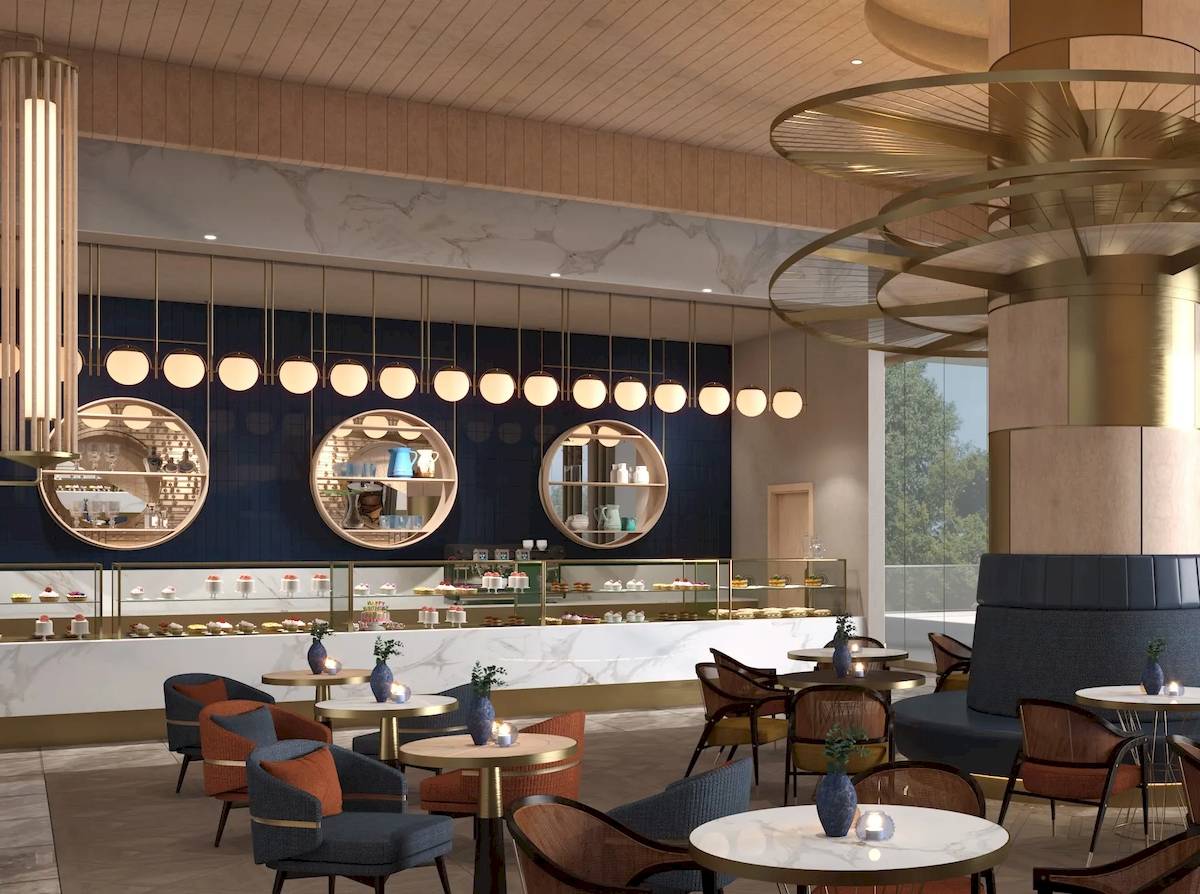 Der Innenbereich des Sunrise Queen Luxury Hotel mit Tisch, Sofa und einer Theke voller Kuchen.