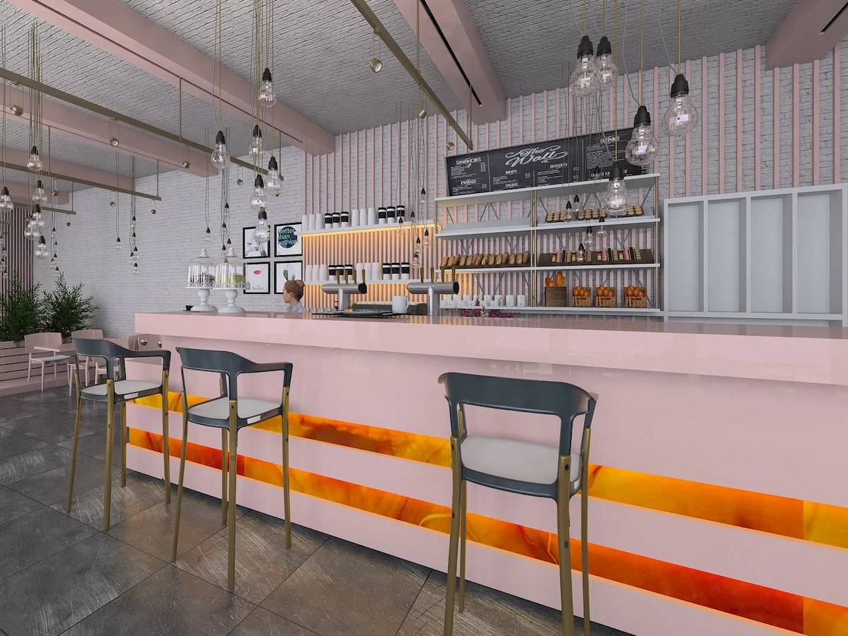 Innenansicht des The Daily Cafe mit rosa Tresen, orange-gelben Akzenten, Barhockern und beleuchteten Lampen.