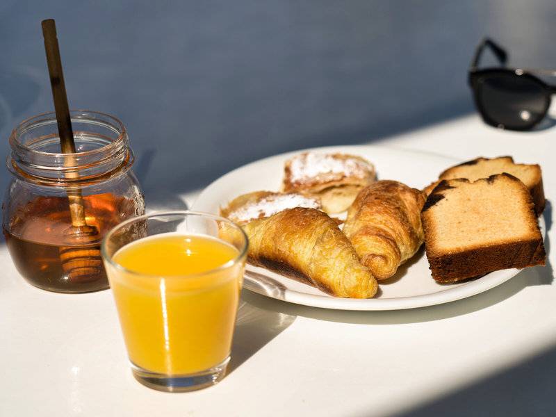 Frühstück im Iris Boutique Hotel mit Croissants, Toast und Orangensaft