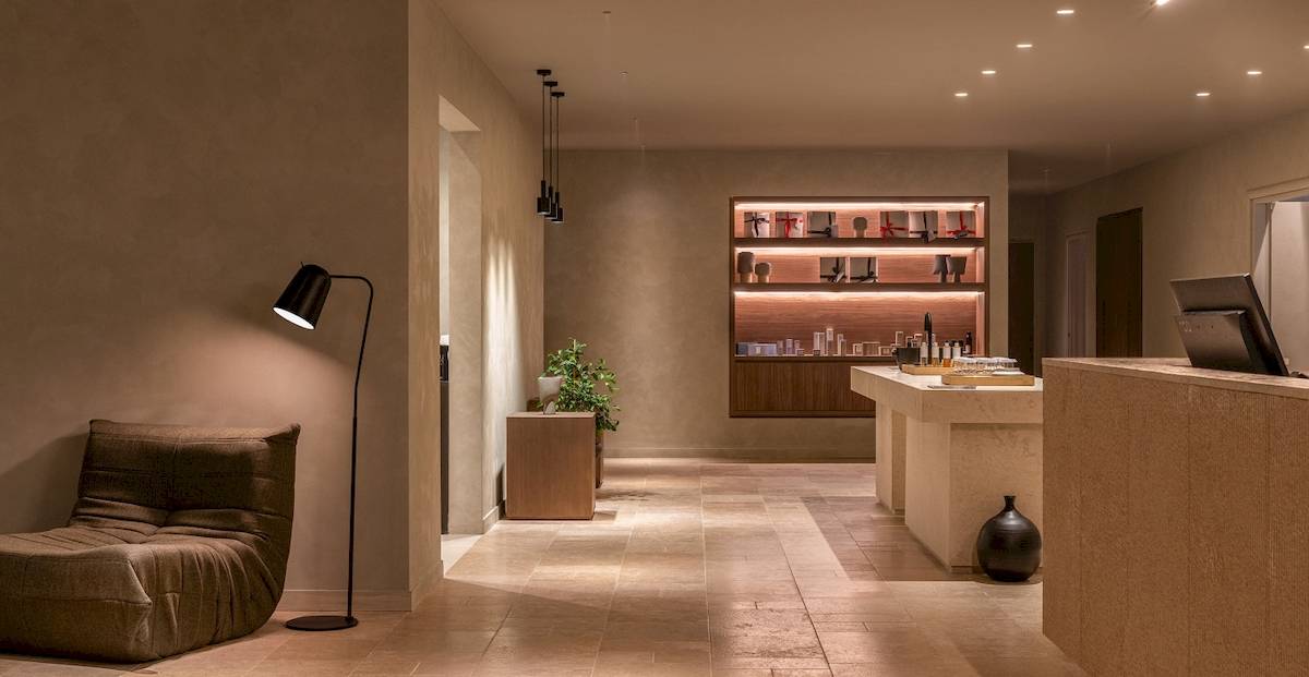Inneneinrichtung des Helea Lifestyle Beach Resort mit einem Sofa, einer Lampe und einem Tisch mit Produkten.
