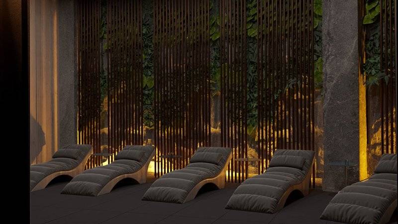 Loungebereich im Ethno Belek Hotel mit grauen Liegen und vertikalen Holzelementen.