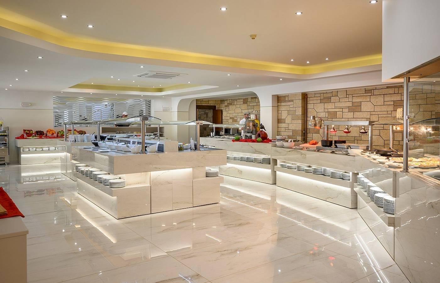 Buffetbereich im Vantaris Palace Hotel mit weißen Marmortischen und verschiedenen Speisen.