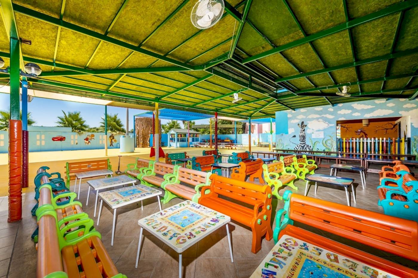 Kindercafe im VONRESORT Golden Coast mit bunten Bänken und Tischen.