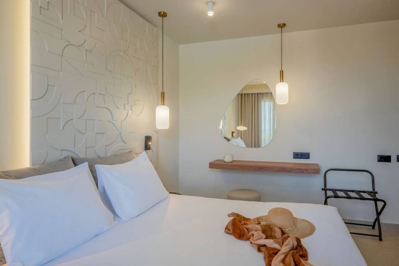 Schlafzimmer im Georgioupolis Resort Aquapark & SPA mit Bett, Dekokissen, und Dekorationen.