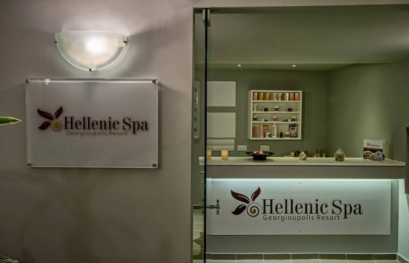 Eingang zum Hellenic Spa im Georgioupolis Resort mit Logo und Beleuchtung.