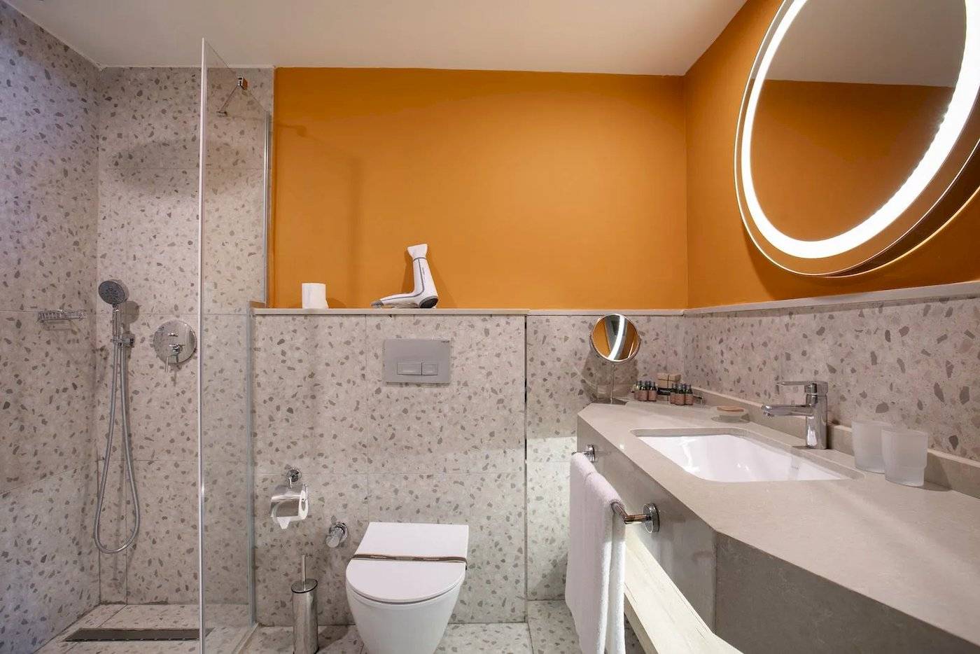 Badezimmer im Megasaray Resort Side mit einer Dusche, Toilette, Waschbecken und Spiegel.