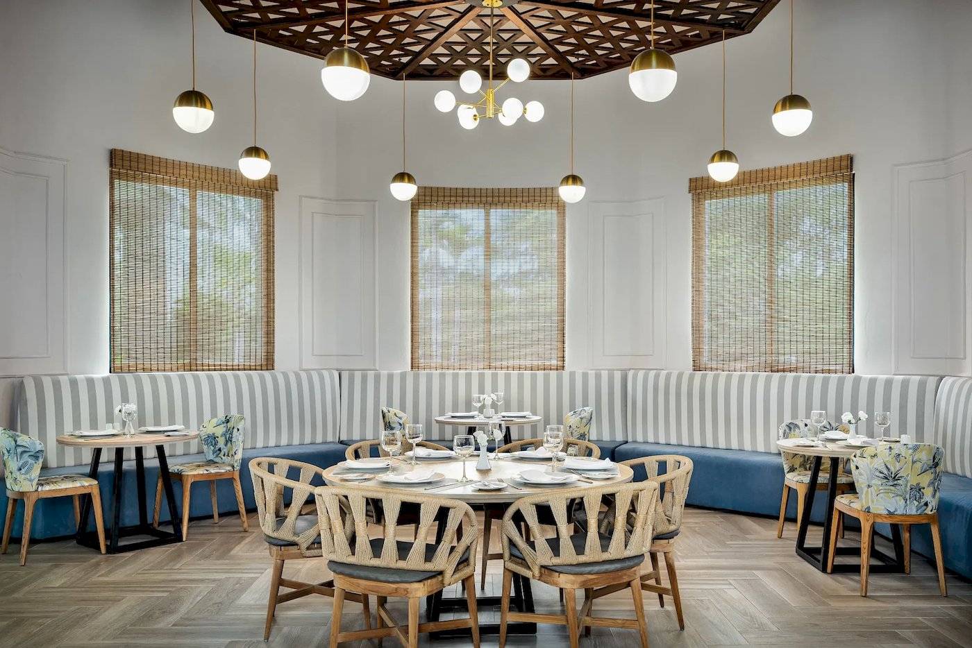 Interieurbereich eines Restaurants mit Tisch, Stühlen und gepolsterten Bänken.